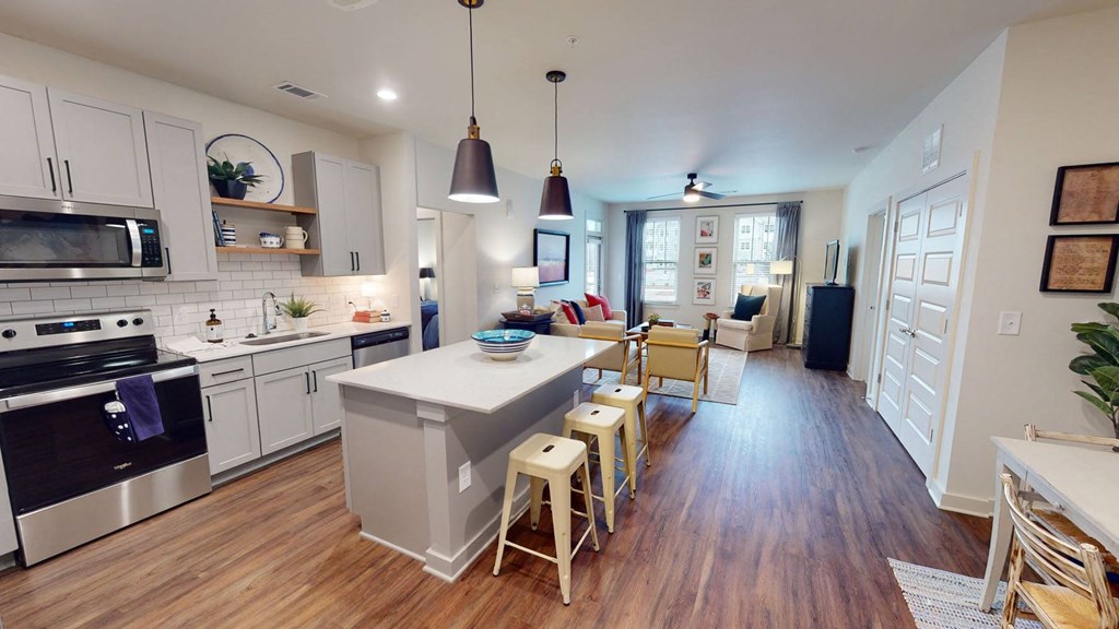 a kitchen and living room with a large island at Walton Fayetteville, Fayetteville, Georgia