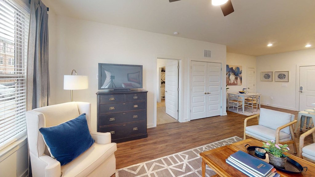 a living room with a tv and a dining room in the background at Walton Fayetteville, Georgia