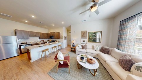 A modern living room with a white sofa and a wooden coffee table.