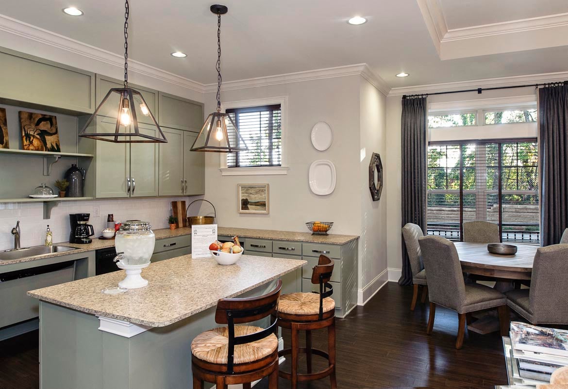 A kitchen with a table and chairs.
