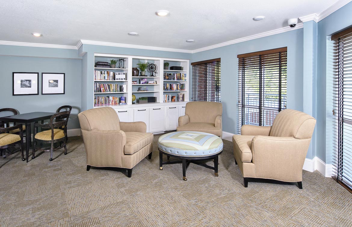 a living room with chairs and a table