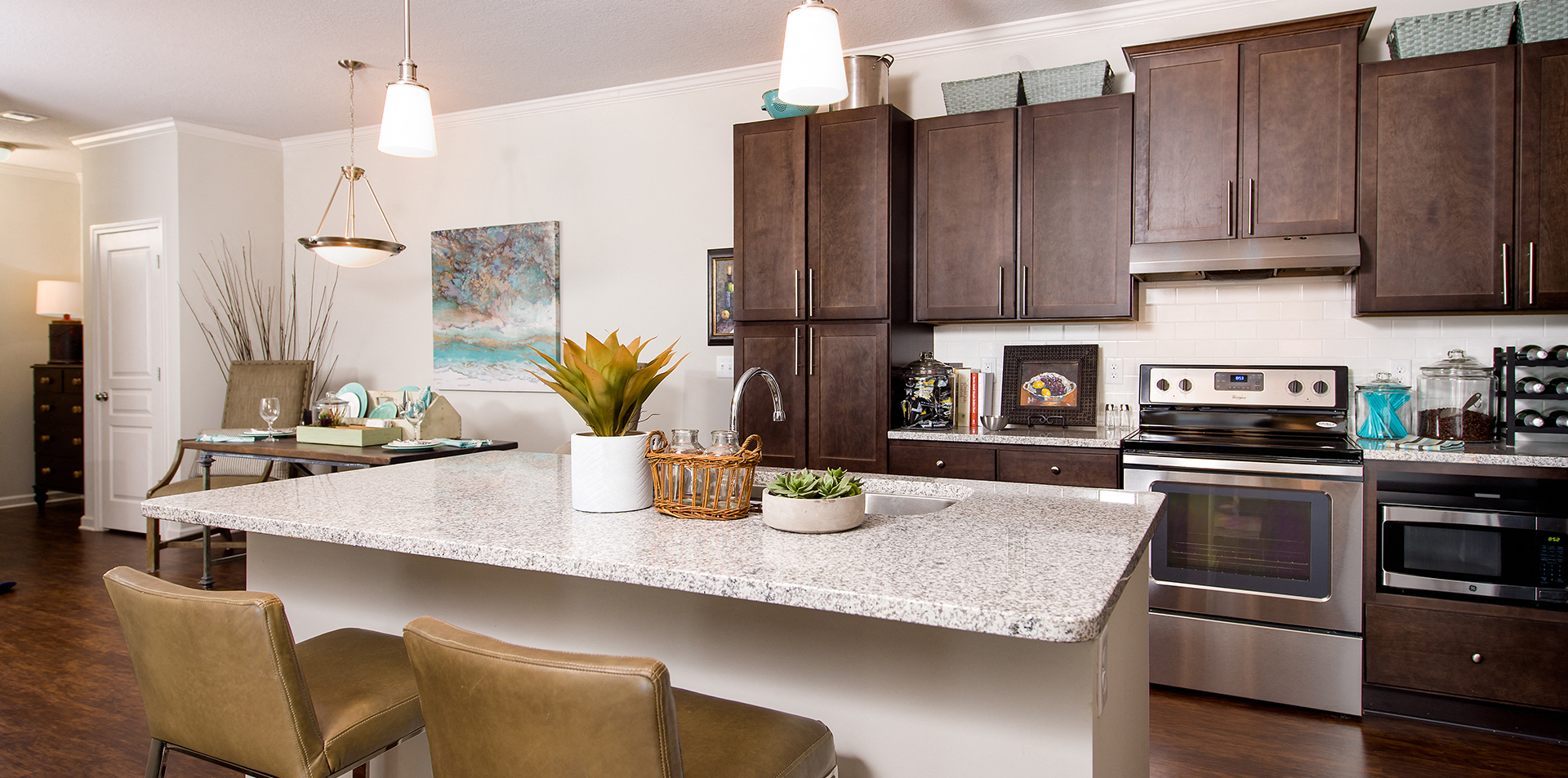 a kitchen with a sink and a stove and a living room