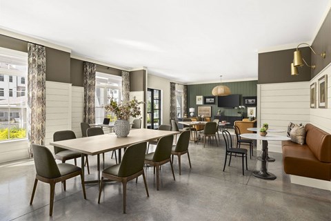 A dining room with a table and chairs.