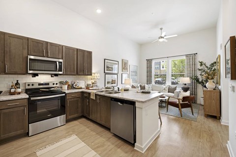 A modern kitchen with a large island and stainless steel appliances.