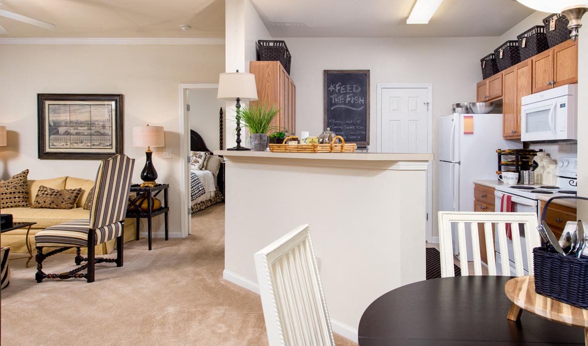 a living room with a kitchen and a dining table
