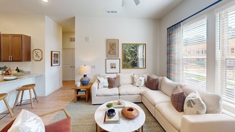 A living room with a white couch and a coffee table.