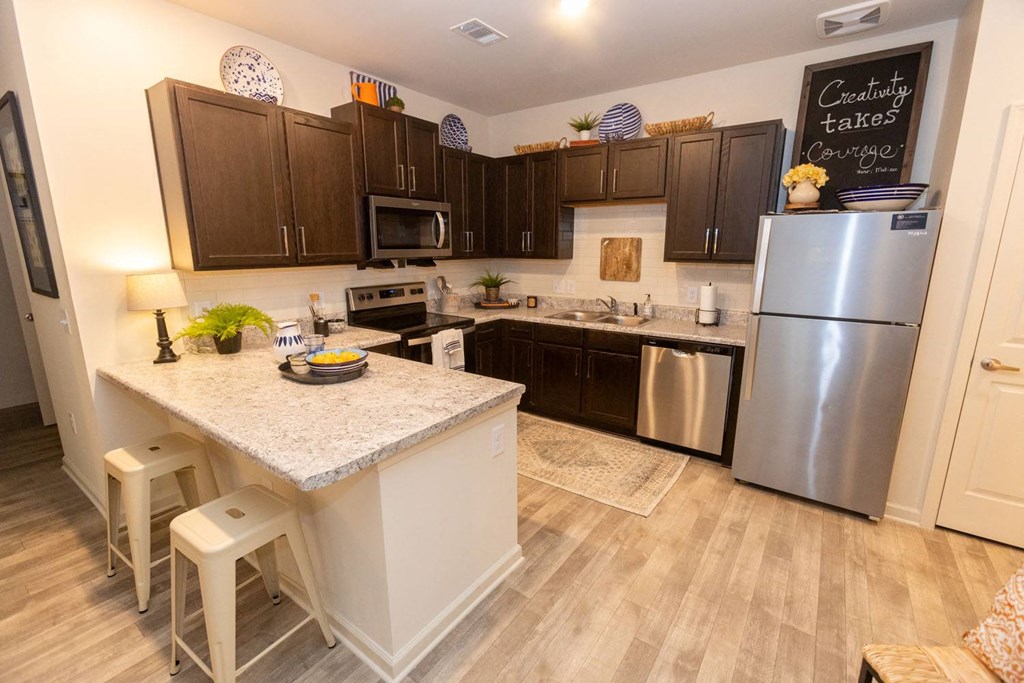 a kitchen with stainless steel appliances and a counter top