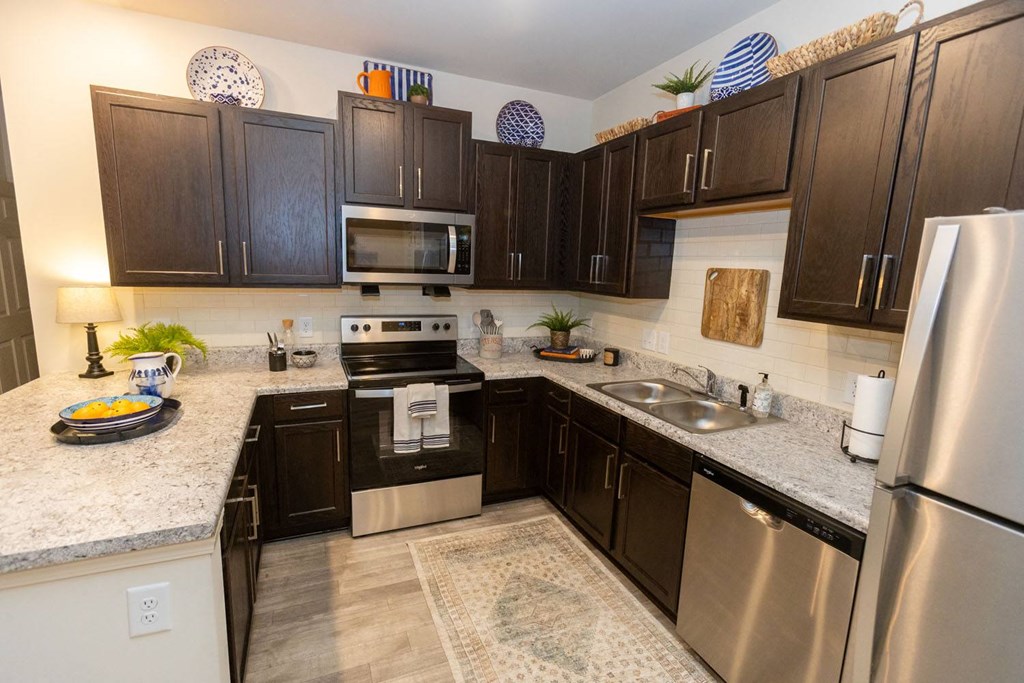 Walton Green family affordable community in Augusta, GA a kitchen with stainless steel appliances and granite counter tops
