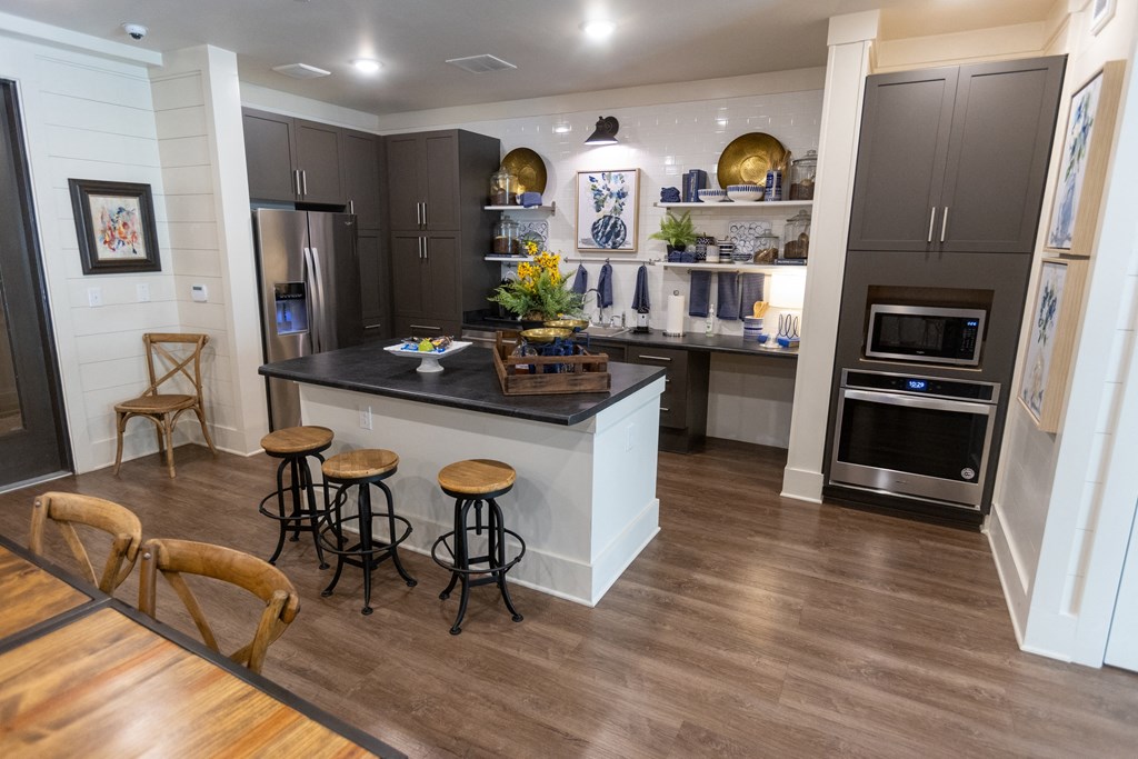 a kitchen with a large center island with a black countertop