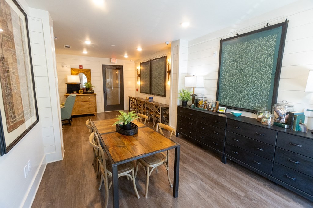a dining room with a wooden table and chairs
