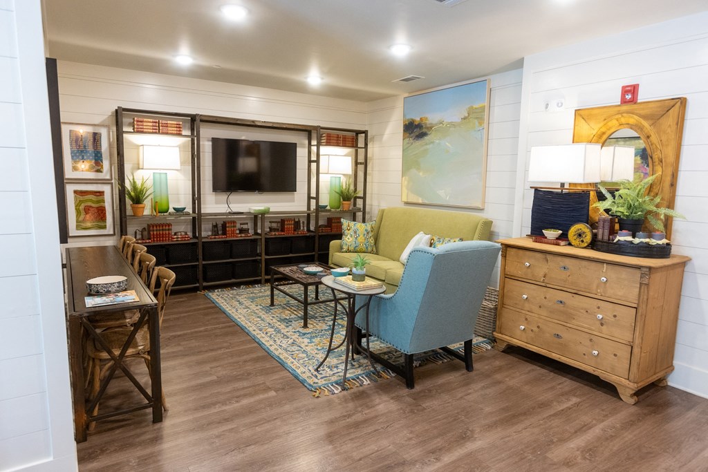 a living room filled with furniture and a flat screen tv