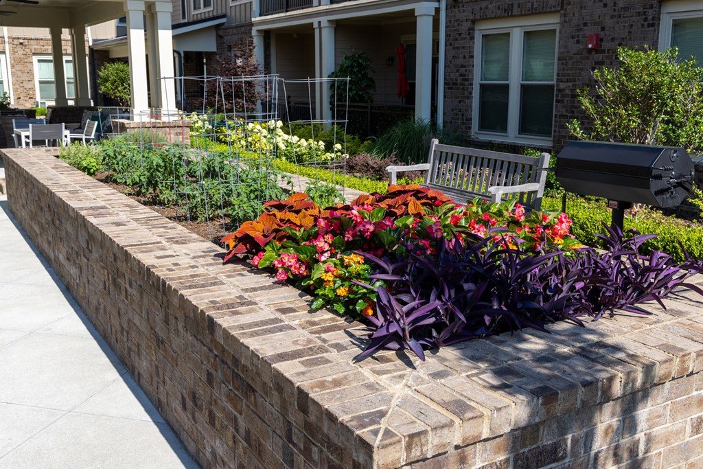 a flower bed in front of a building