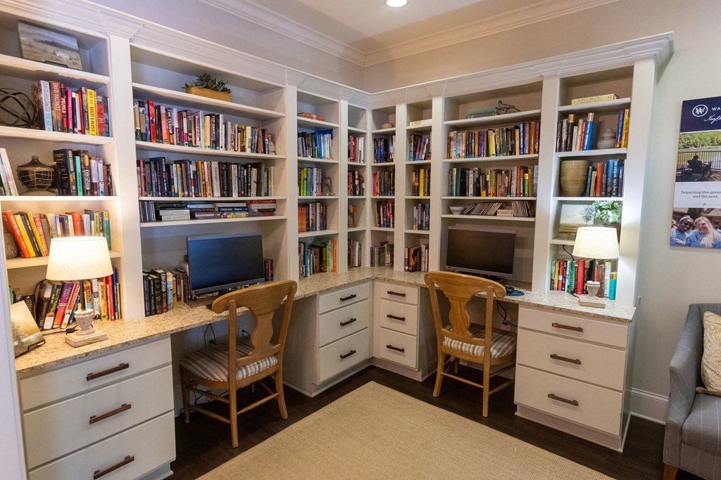 a home office with white cabinetry and a granite countertop