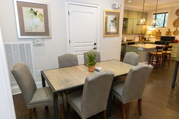 a dining room and kitchen with a table and chairs