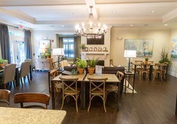a dining room and living room with a table and chairs