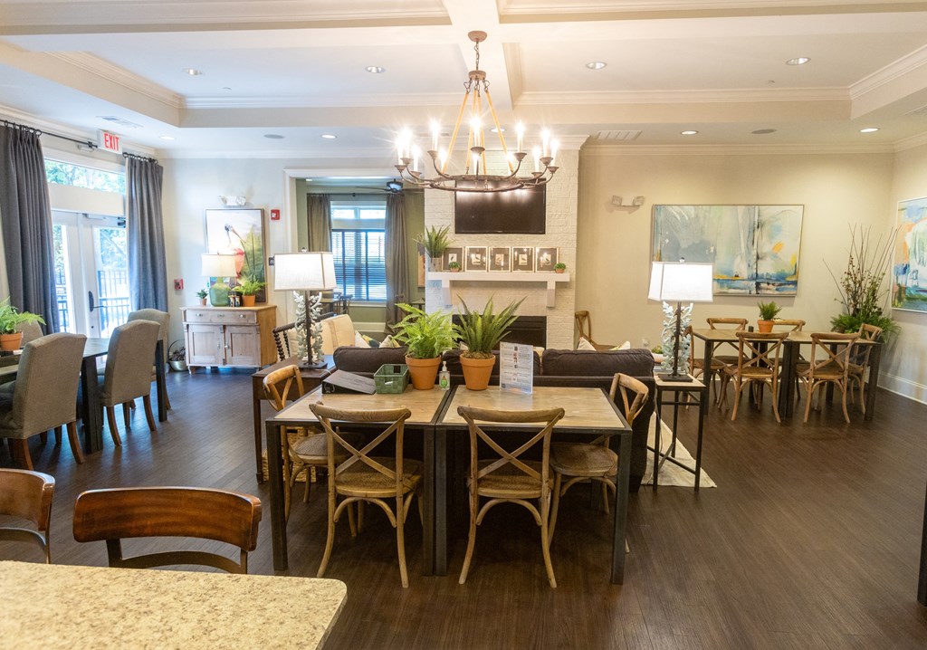 a dining room and living room with a chandelier