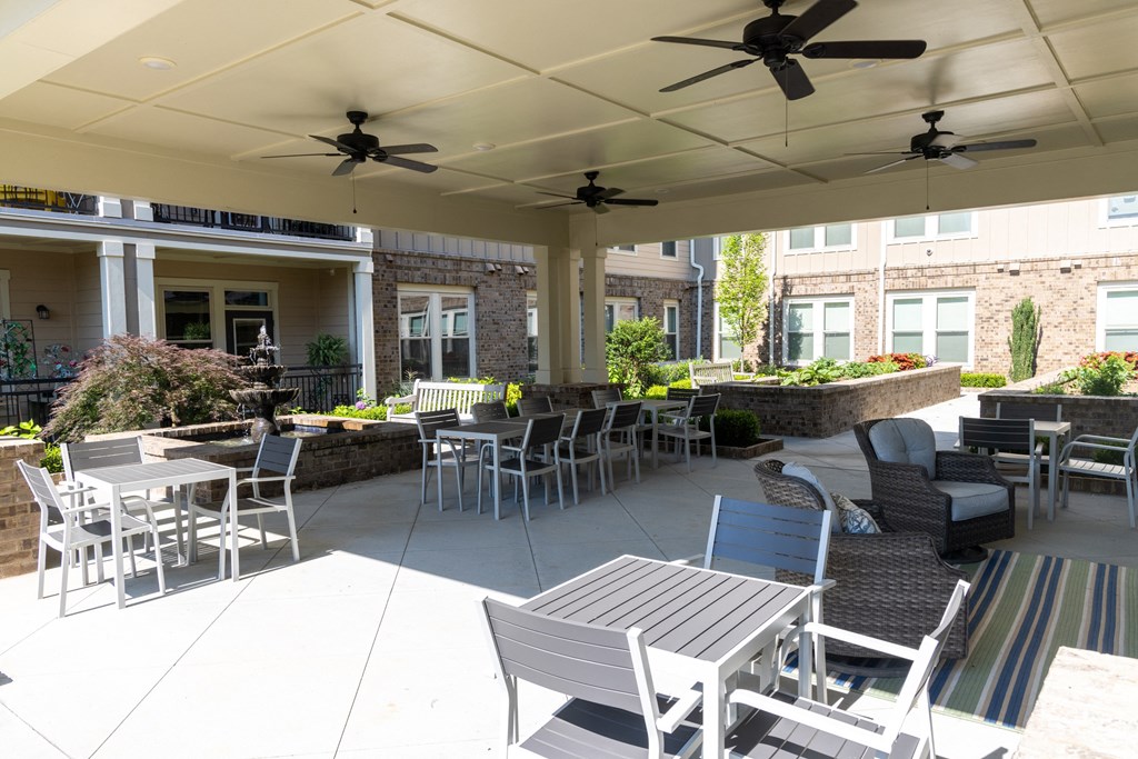 an outdoor patio with tables and chairs