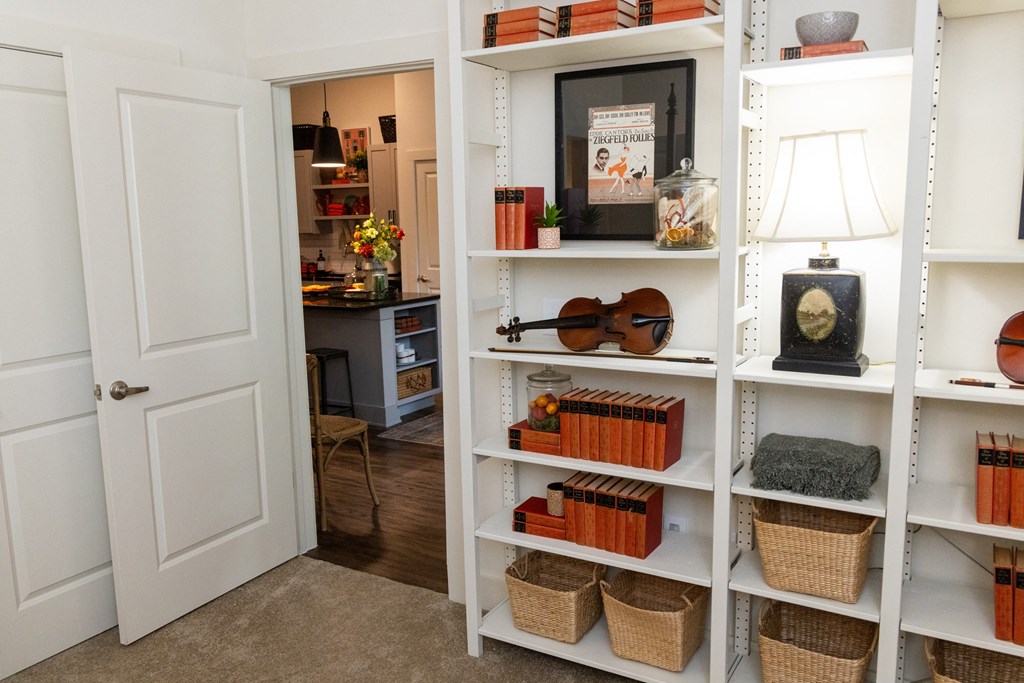 this is a photo of a bookcase in a home with a door open to the office