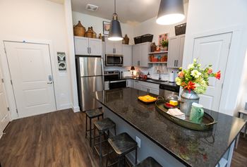 a kitchen with a large island and stainless steel appliances