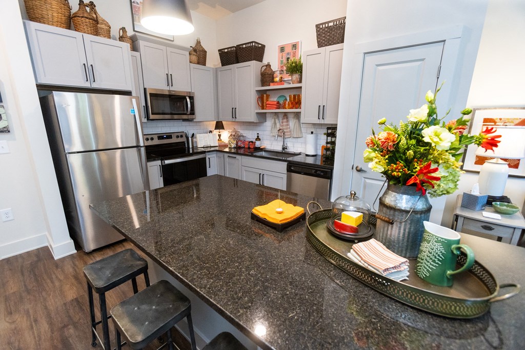 a kitchen with a granite counter top and stainless steel appliances