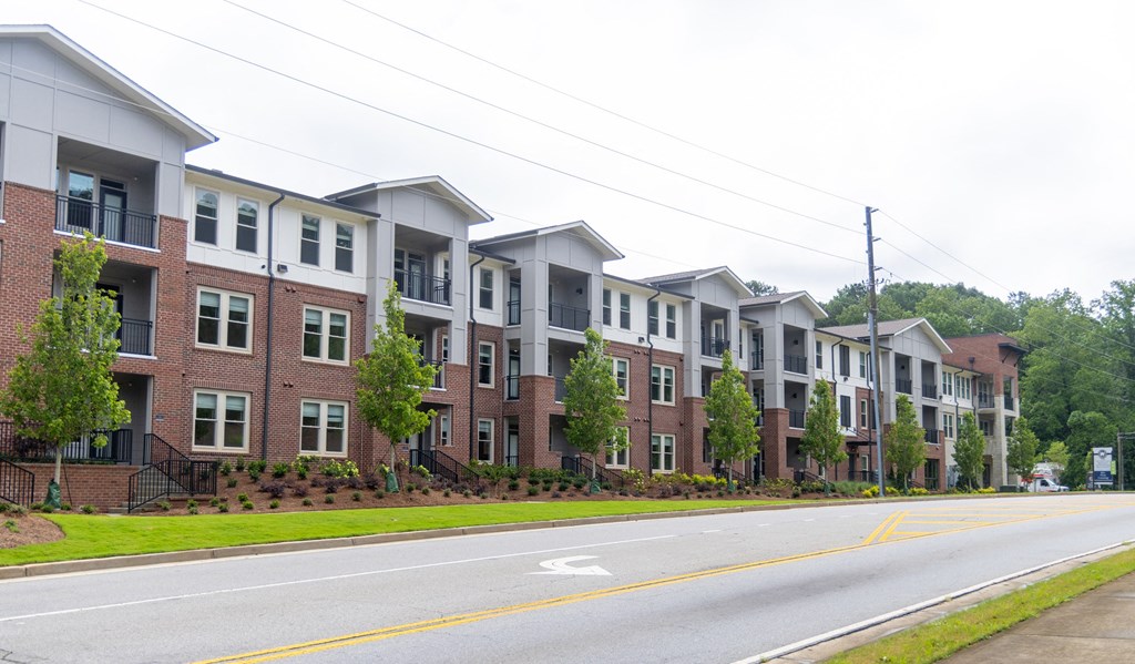 a row of apartment buildings on a street