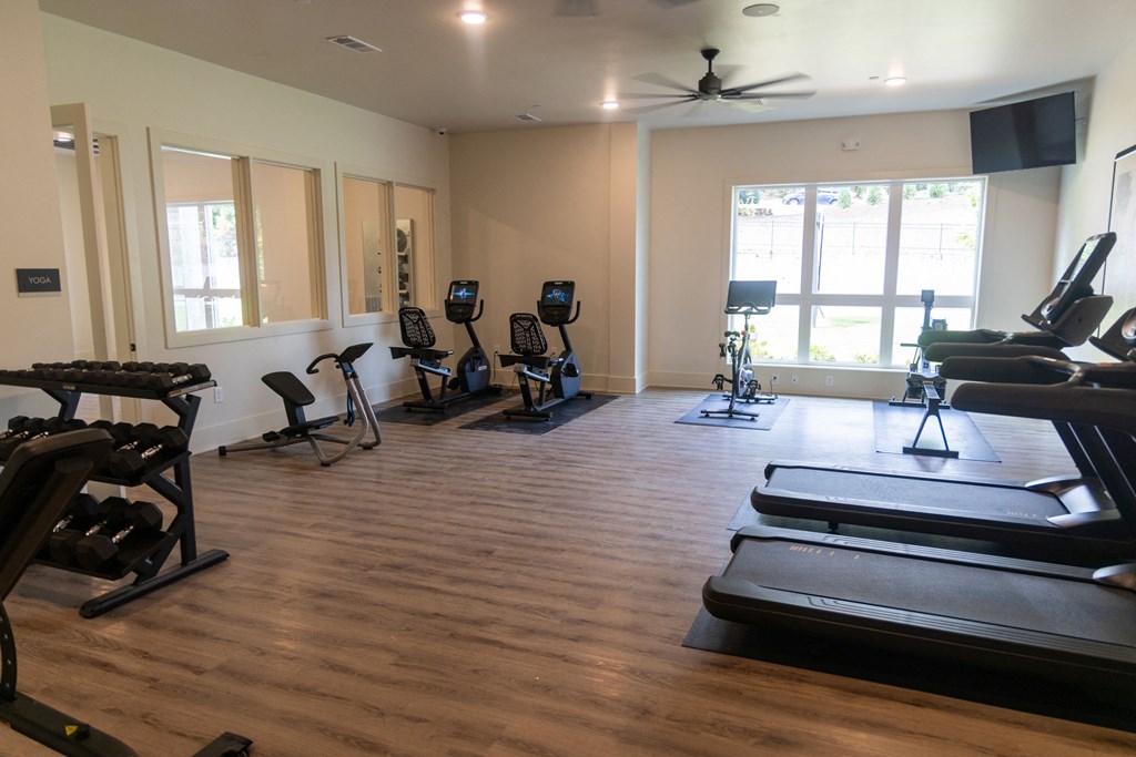 a gym with treadmills and other exercise equipment