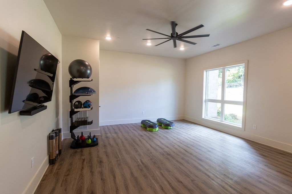 a living room with hardwood floors and a ceiling fan