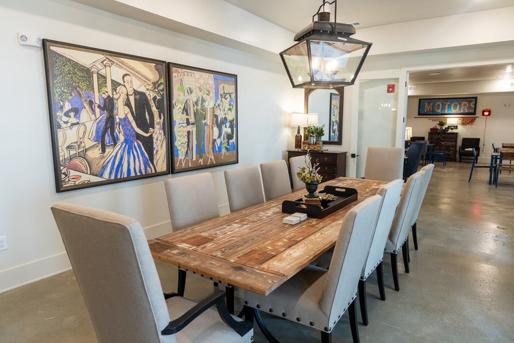 a dining room with a long wooden table and gray chairs