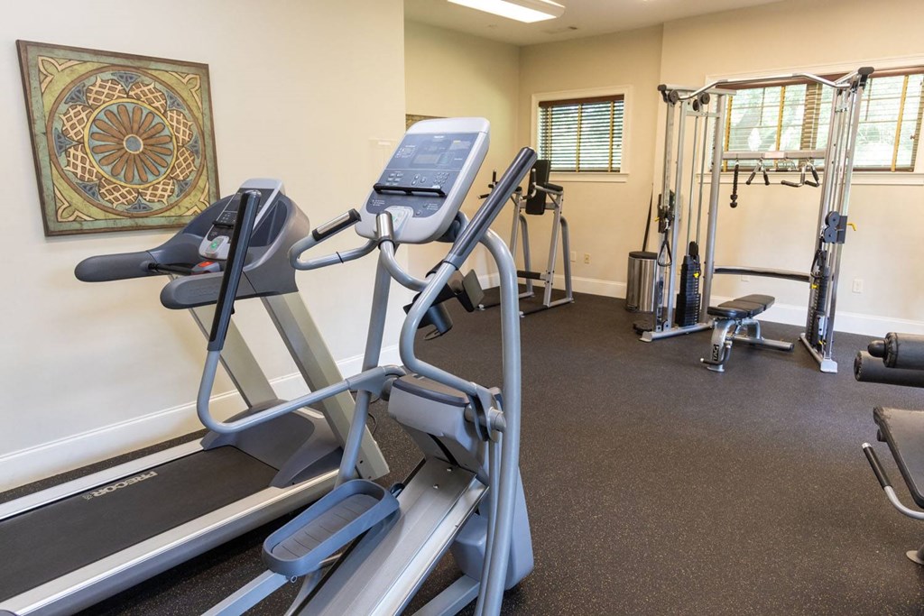 a room with a treadmill and other exercise equipment
