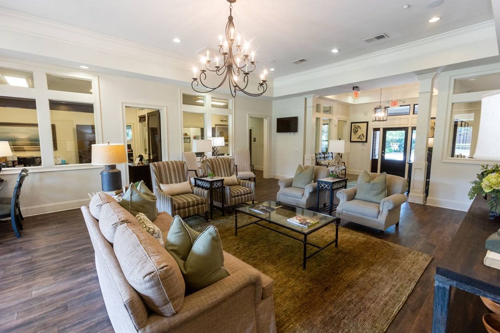 a living room filled with furniture and a chandelier