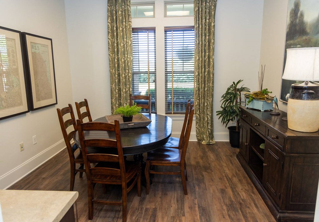 a dining room with a table and chairs