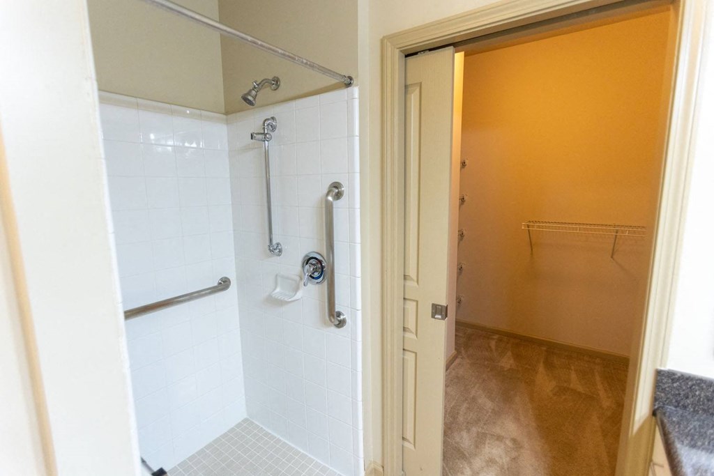 a bathroom with a shower and a door that is open