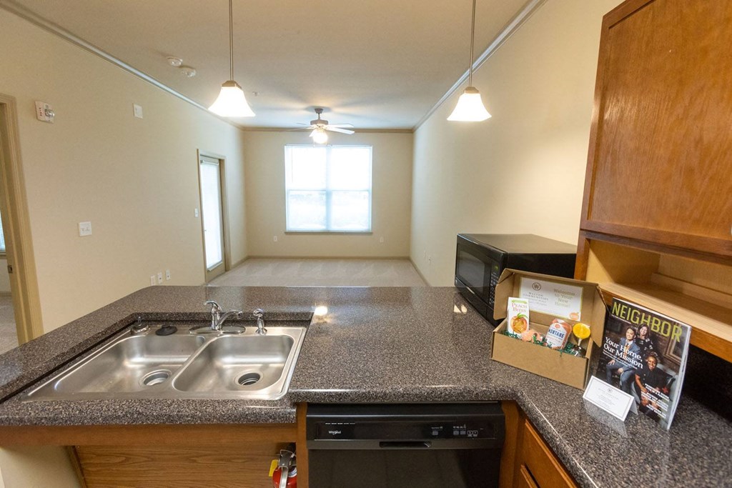 a kitchen with granite countertops and a stainless steel sink