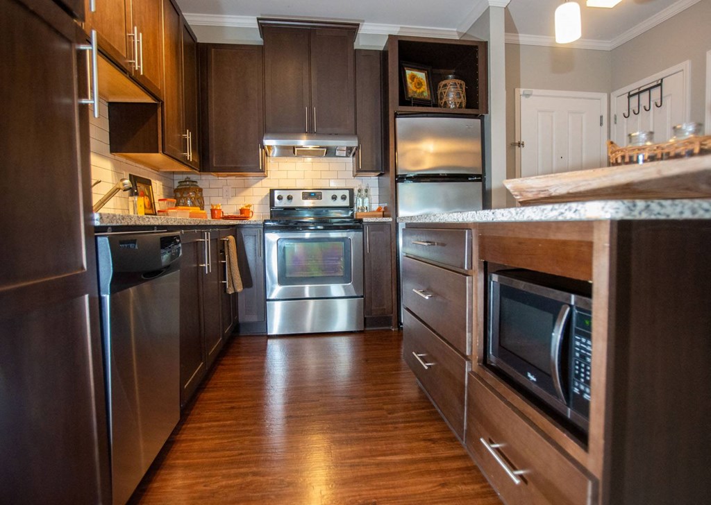 a kitchen with stainless steel appliances and wooden cabinets