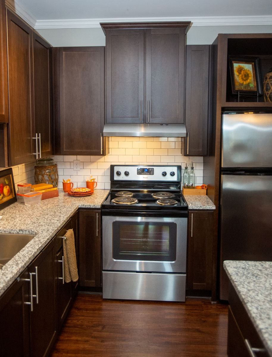 a kitchen with stainless steel appliances and wooden cabinets