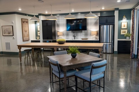 A modern dining room with a wooden table and chairs.