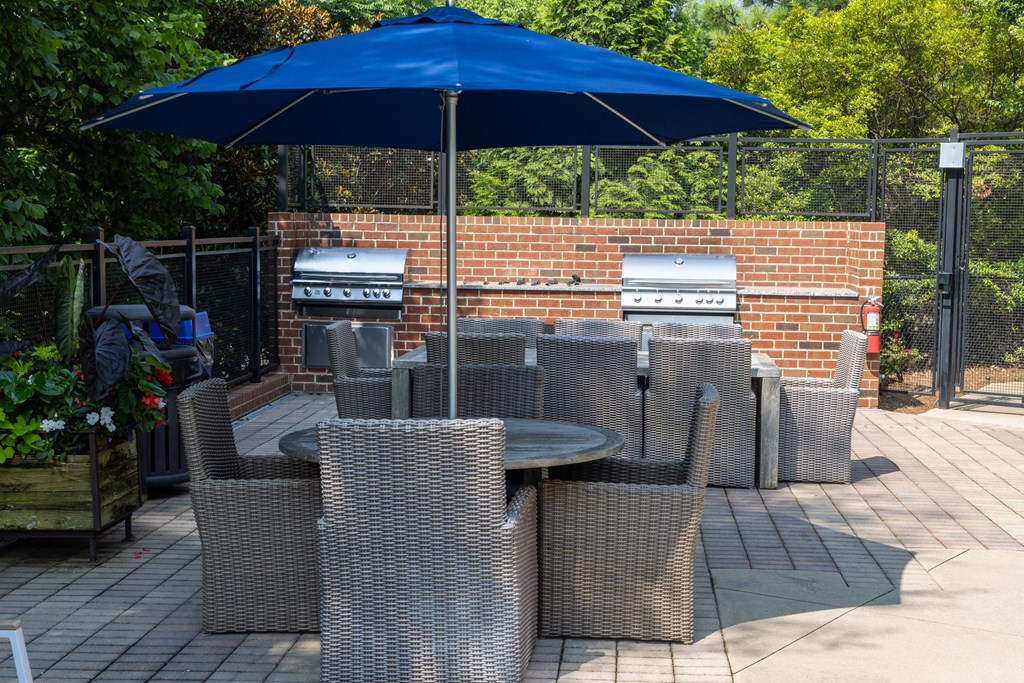 a patio with a table and chairs and an umbrella