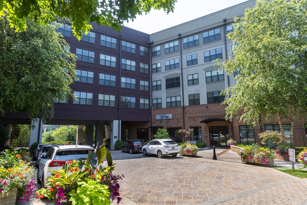 a large brick building with a parking lot in front of it