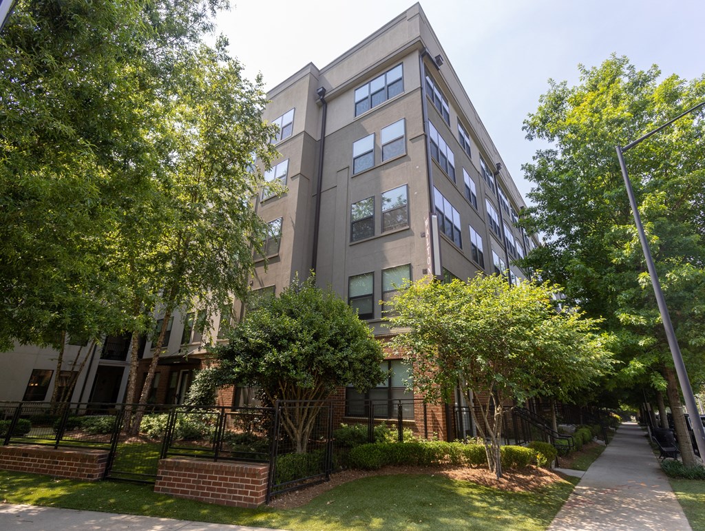 a large apartment building with trees in front of it