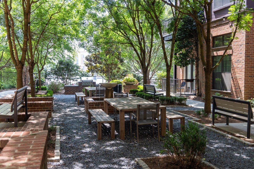 a courtyard with wooden tables and benches