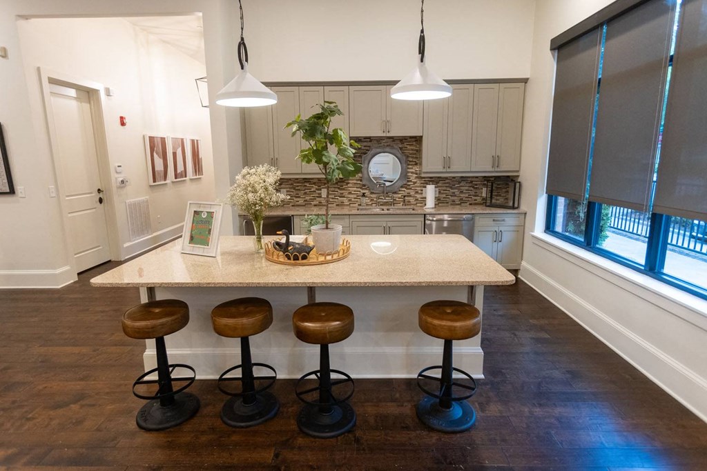 Woodstock West by Walton Community Room coffee station  a kitchen with a large island with four stools