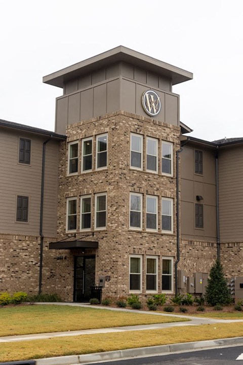 A building with a circular logo on the top of it.