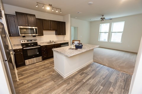 A kitchen with a white island in the middle of the room.