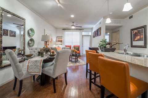 A dining room with a table set for four.