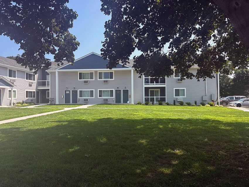 Exterior from Easy Street a large green lawn in front of a large gray building