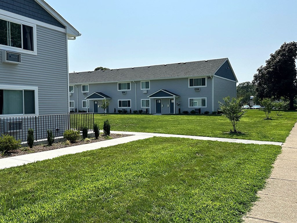 a grassy area with a house in the background at Brookwood at Sayville, Sayville, New York