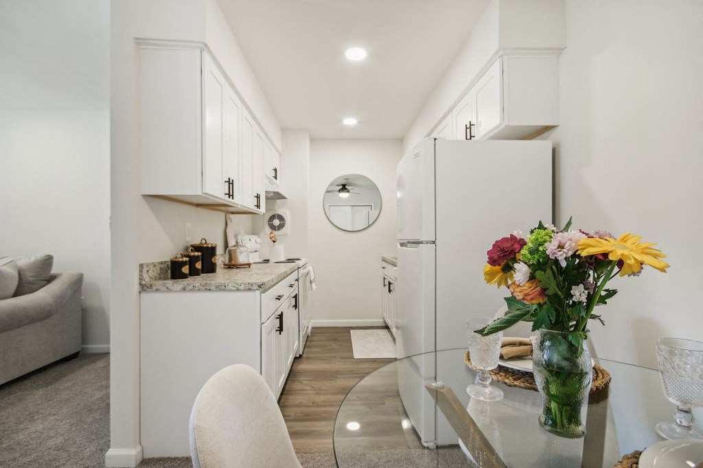a view of beautiful white kitchen and dining room area at Brookwood at Ridge, New York, 11961