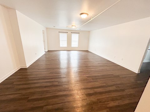 A room with wooden flooring and a window.