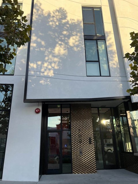 the front of a building with a door and windows