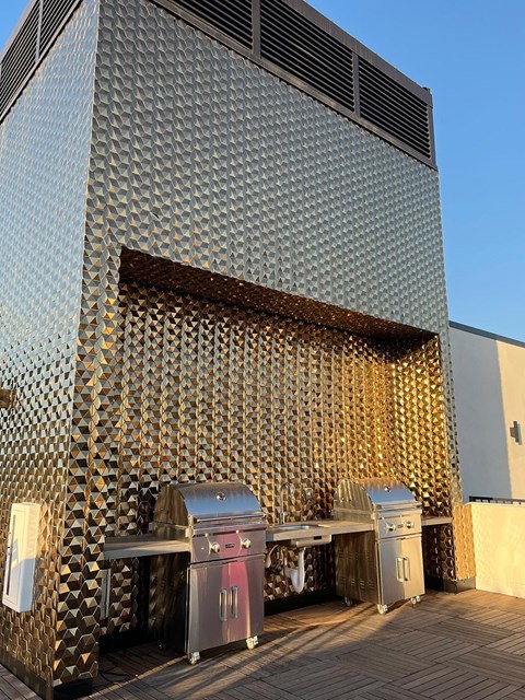 the side of a building with three trash cans in front of it
